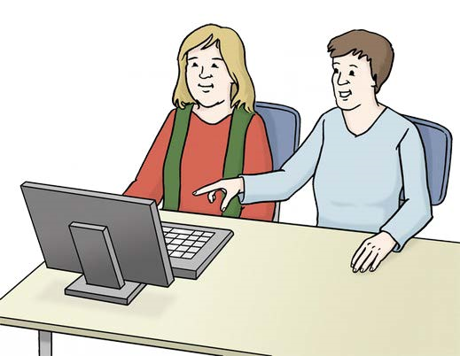 Ein Mensch arbeitet gemeinsam mit seiner Assistenz an einem Computer.